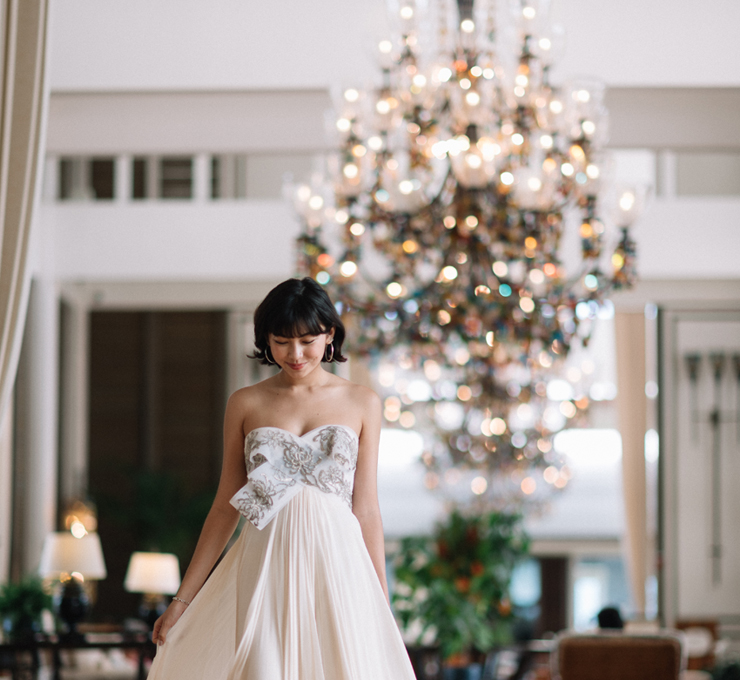 bride standing in front of chandelier