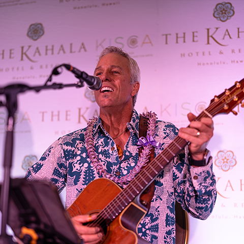 man playing guitar and singing