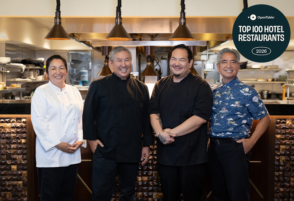 the group of chefs standing in front of the kitchen
