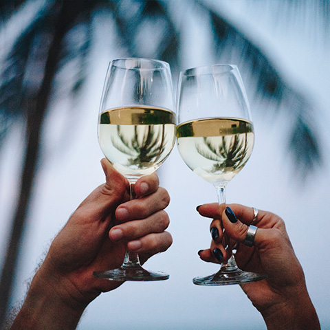 two hands holding glasses